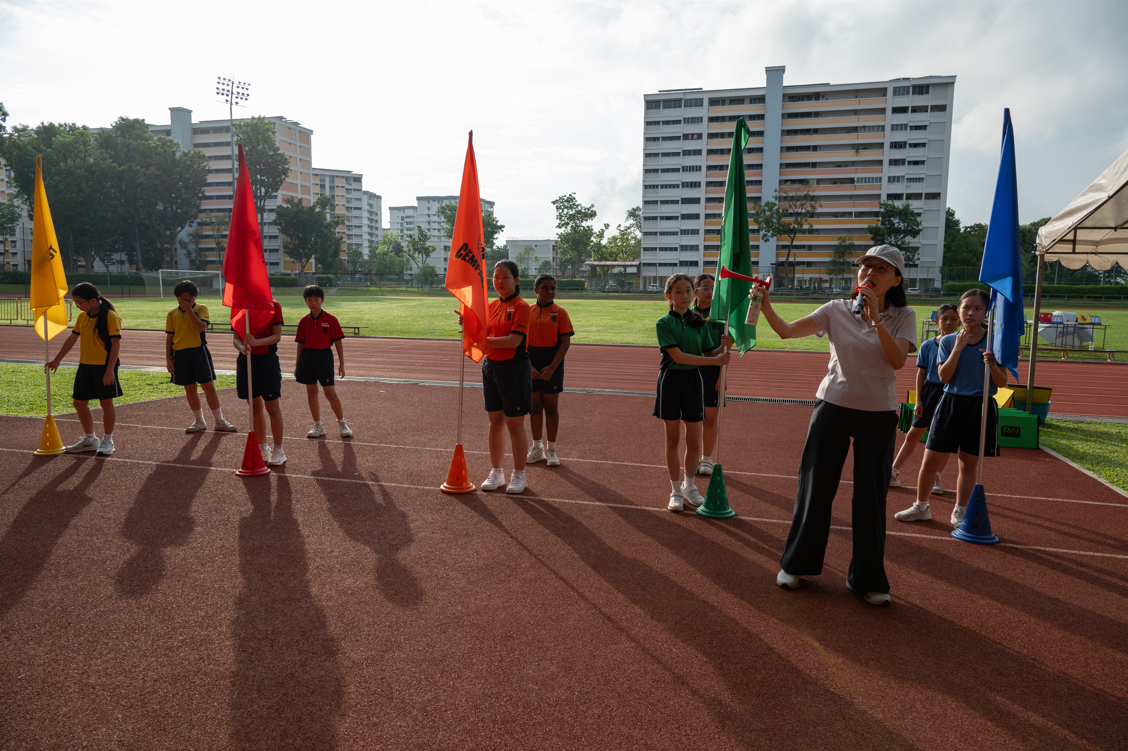 Students holding team flags at the track.